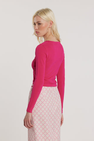 Maglia ADELE maniche lunghe scollo alla madonna con finta apertura più bottoni più applicazioni logo e fiocco